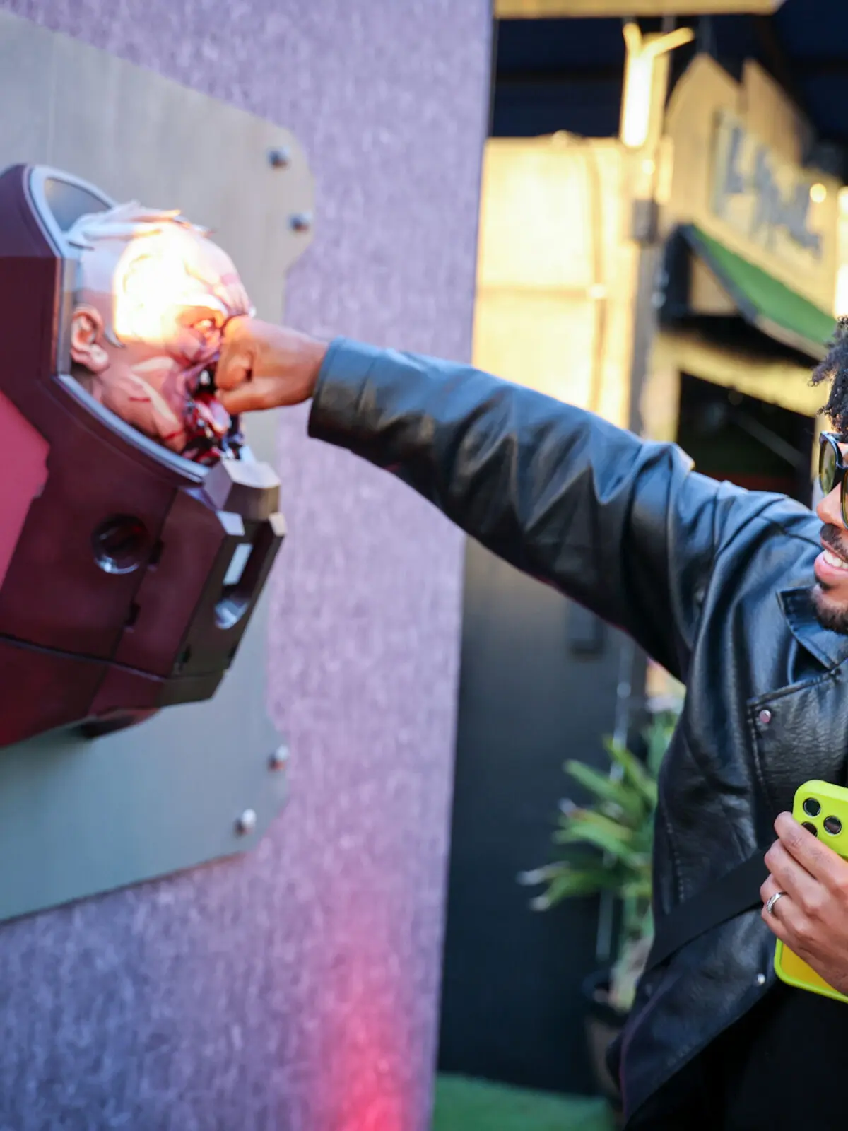 Creator @your.royal.freshness playfully punches a custom 3D-printed sculpture of the battle-damaged Invincible villain Conquest at Prime Video’s Season 4 creator event.