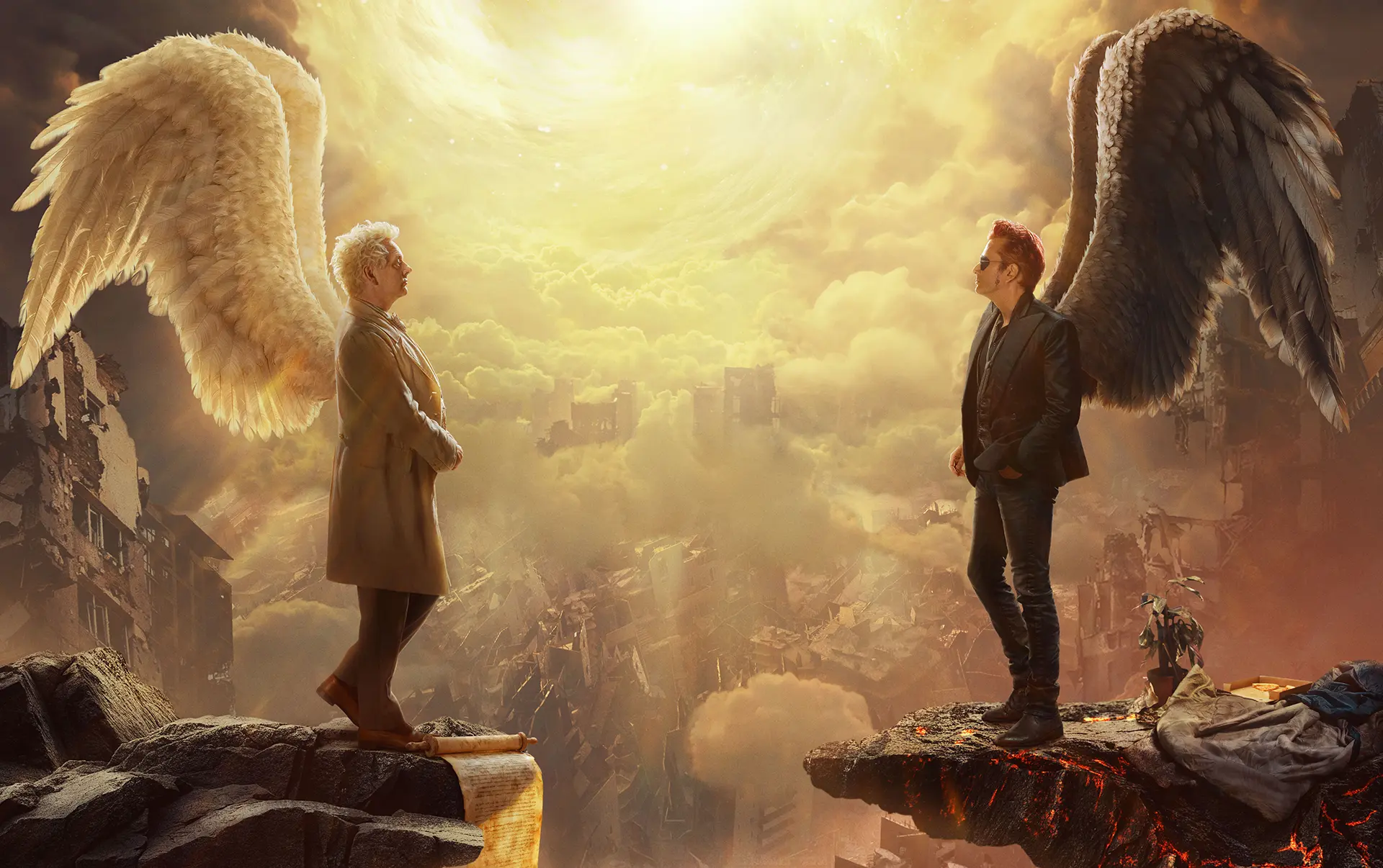 Aziraphale and Crowley, each with large angelic wings, stand on opposite rocky ledges above a ruined city under a bright, swirling celestial light.