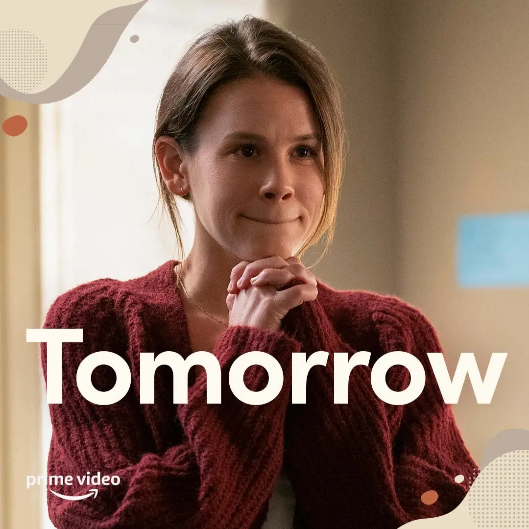 Close-up of Mandy in a burgundy sweater, hands clasped near her chin, with large white word “Tomorrow” across the lower frame and a small Prime Video logo in the bottom left.