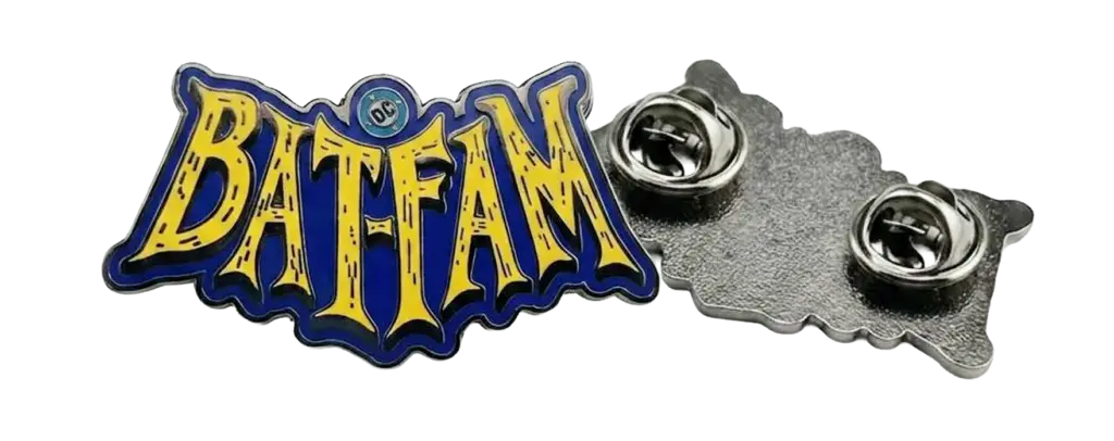 Yellow Bat‑Fam stylized logotype enamel pin with blue outline and small DC emblem at top, shown alongside its metal backing with two butterfly clutch pin closures.