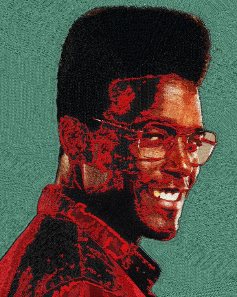 Yarn-textured portrait of Luke James for Prime Video’s THEM: The Scare, featuring a high-top fade, glasses, layered stitching, and a muted teal fabric background.