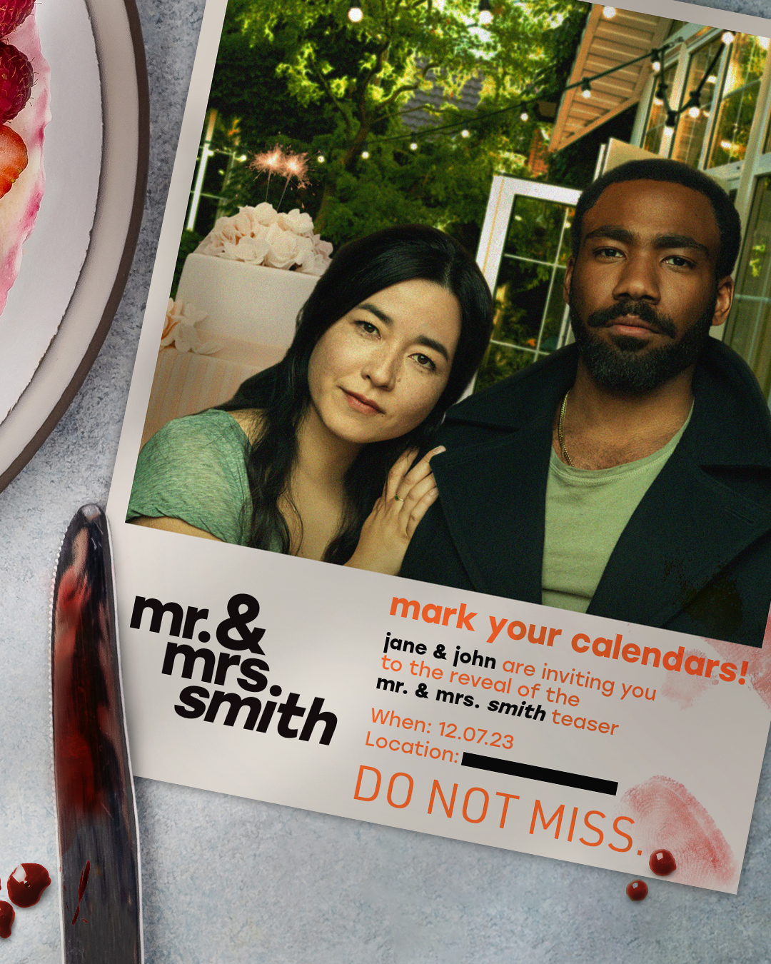 Portrait of Maya Erskine and Donald Glover as Jane and John Smith on a save-the-date postcard, wedding cake with sparkler behind them, knife with red droplets at the lower left.