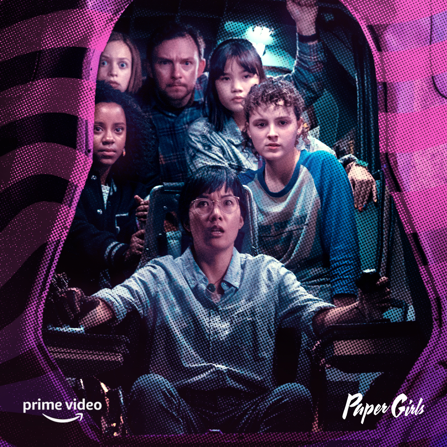 Six people crowded inside a retro vehicle seen through a pink halftone border, a bespectacled young woman at the front gripping controls with a tense, wide-eyed expression.