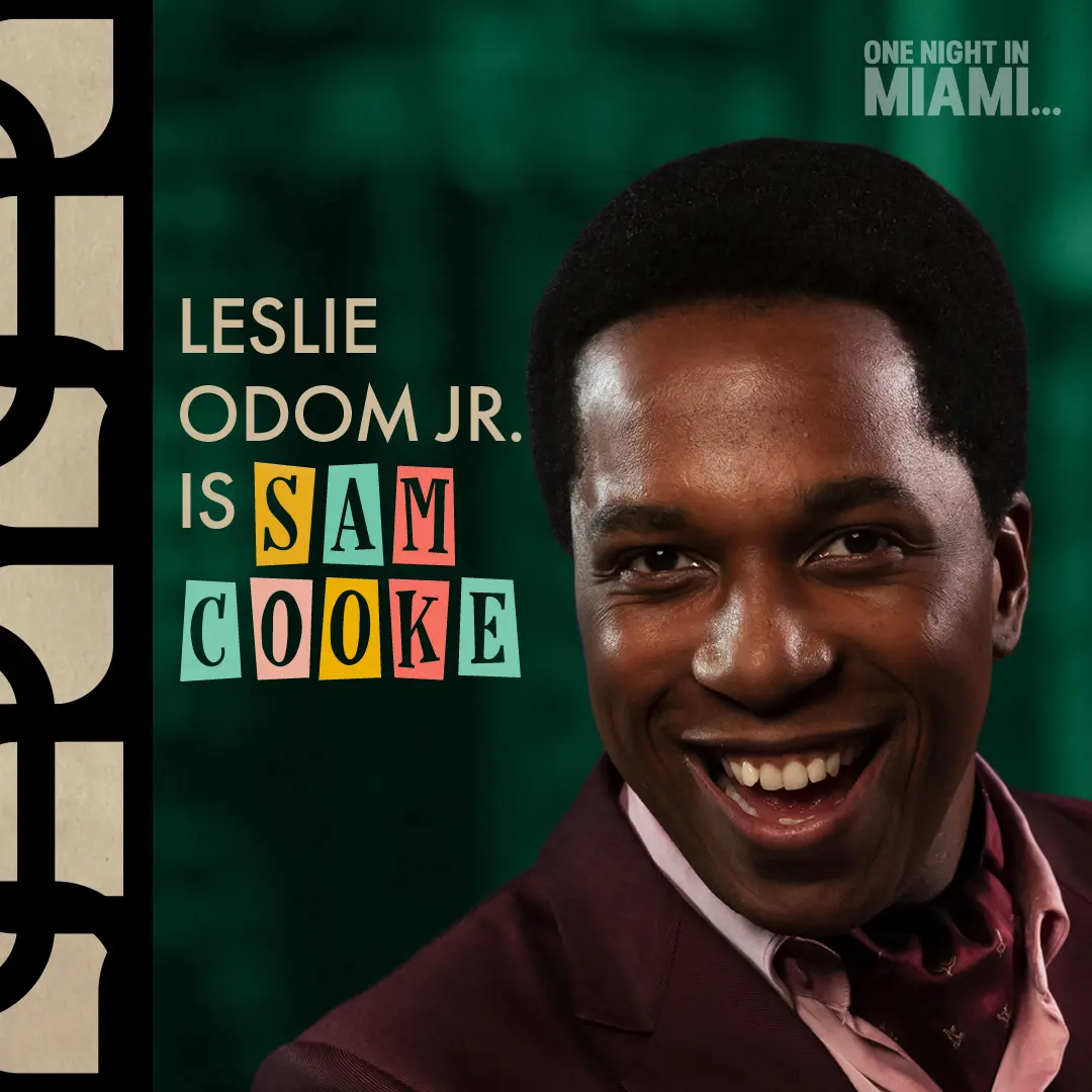 Close-up portrait of Leslie Odom Jr. smiling in a maroon suit, pink shirt and neckerchief against a deep green textured background with cut-paper lettering that reads 'Sam Cooke'.