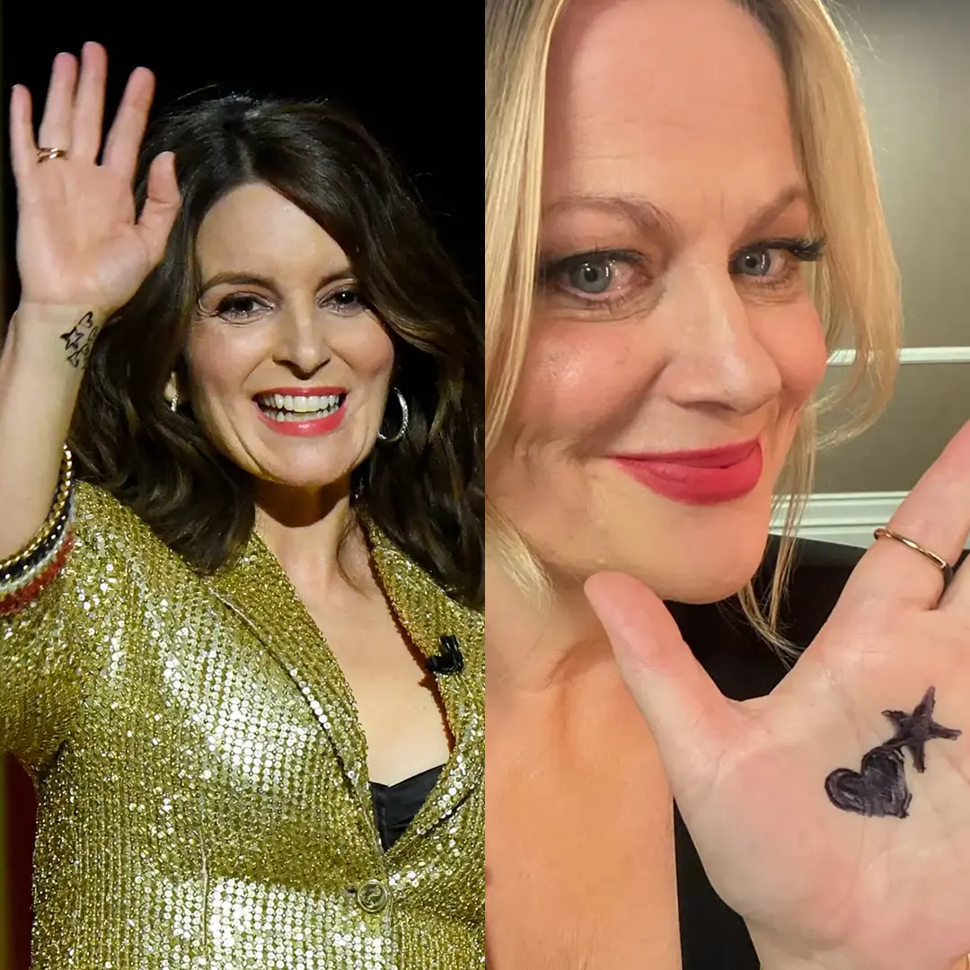 Amy Poehler and Tina Fey show the hand-drawn heart-and-star symbols worn during their hosting of the 2021 Golden Globes.