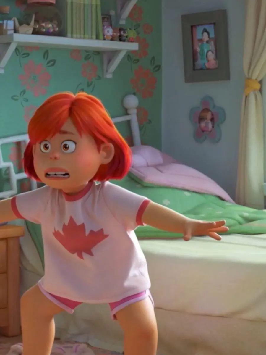 13-year-old girl with red hair and a maple-leaf t-shirt stands barefoot with arms out and a startled expression in a pastel bedroom filled with plush toys and floral wallpaper.