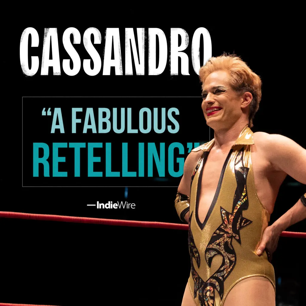 CASSANDRO review graphic featuring Cassandro in gold-and-black wrestling gear beside IndieWire’s quote, “A fabulous retelling.”